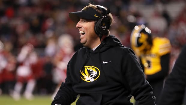 Nov 24, 2023; Fayetteville, Arkansas, USA; Missouri Tigers head coach Eli Drinkwitz celebrates after a defensive touchdown in the third quarter against the Arkansas Razorbacks at Donald W. Reynolds Razorback Stadium. Missouri won 48-14. Mandatory Credit: Nelson Chenault-USA TODAY Sports  